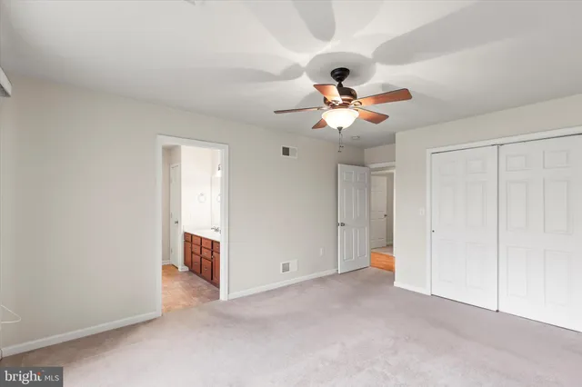 a view of a room with a ceiling fan