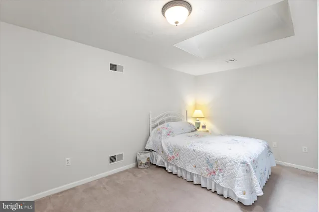 a bedroom with a bed and a lamp