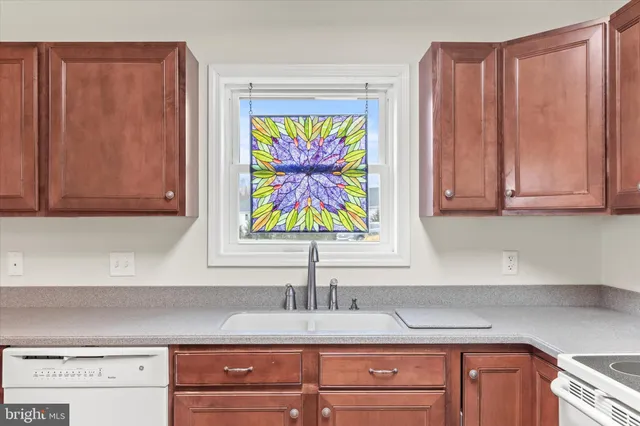 a kitchen with stainless steel appliances white cabinets and a refrigerator