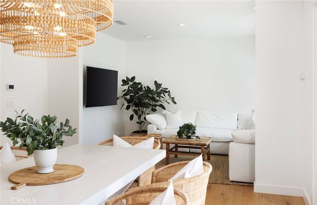a dining room with furniture a potted plant and a fireplace