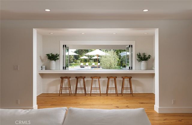 a large white kitchen with a large window