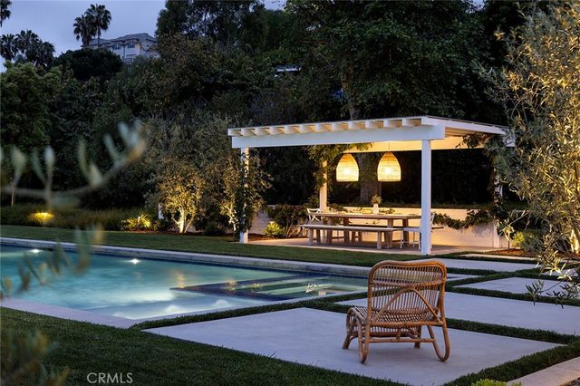 a front view of a house with glass windows and garage