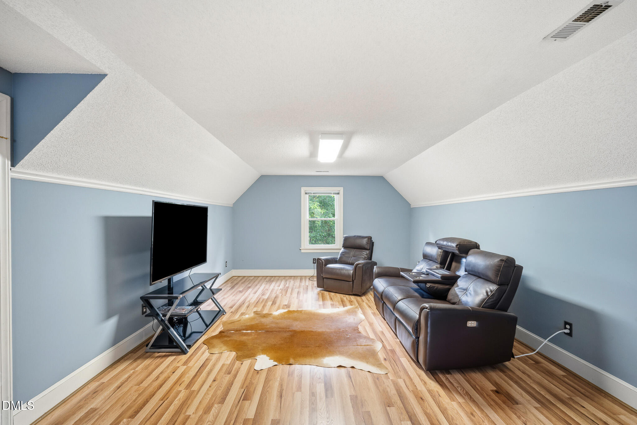 3735 Stoneybrook Drive Durham, NC 27705 - Photo 32 of 44 a living room with furniture and a flat screen tv