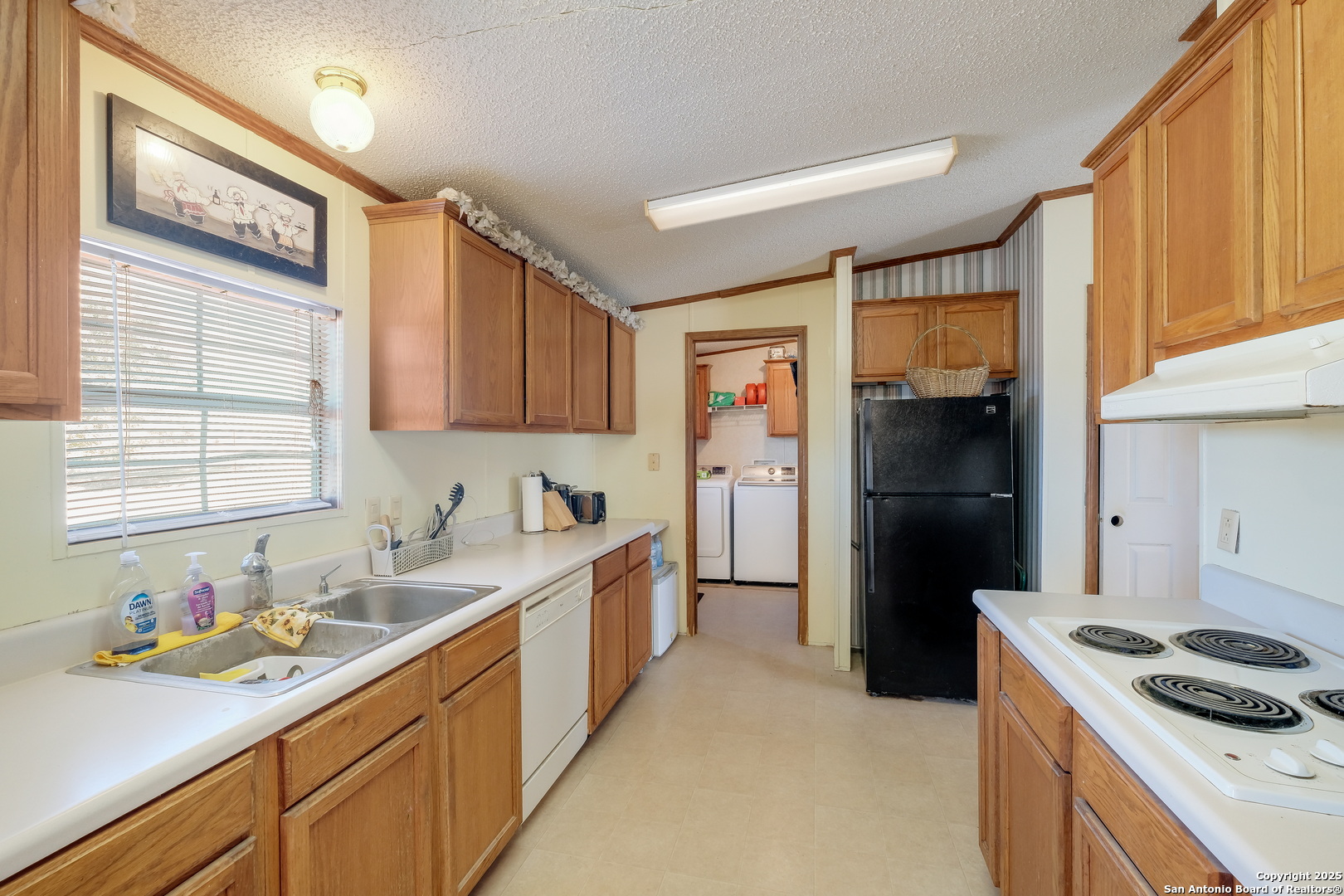 104 Kickapoo Trail Seguin, TX 78155 - Photo 12 of 21 a kitchen with a sink stove and refrigerator