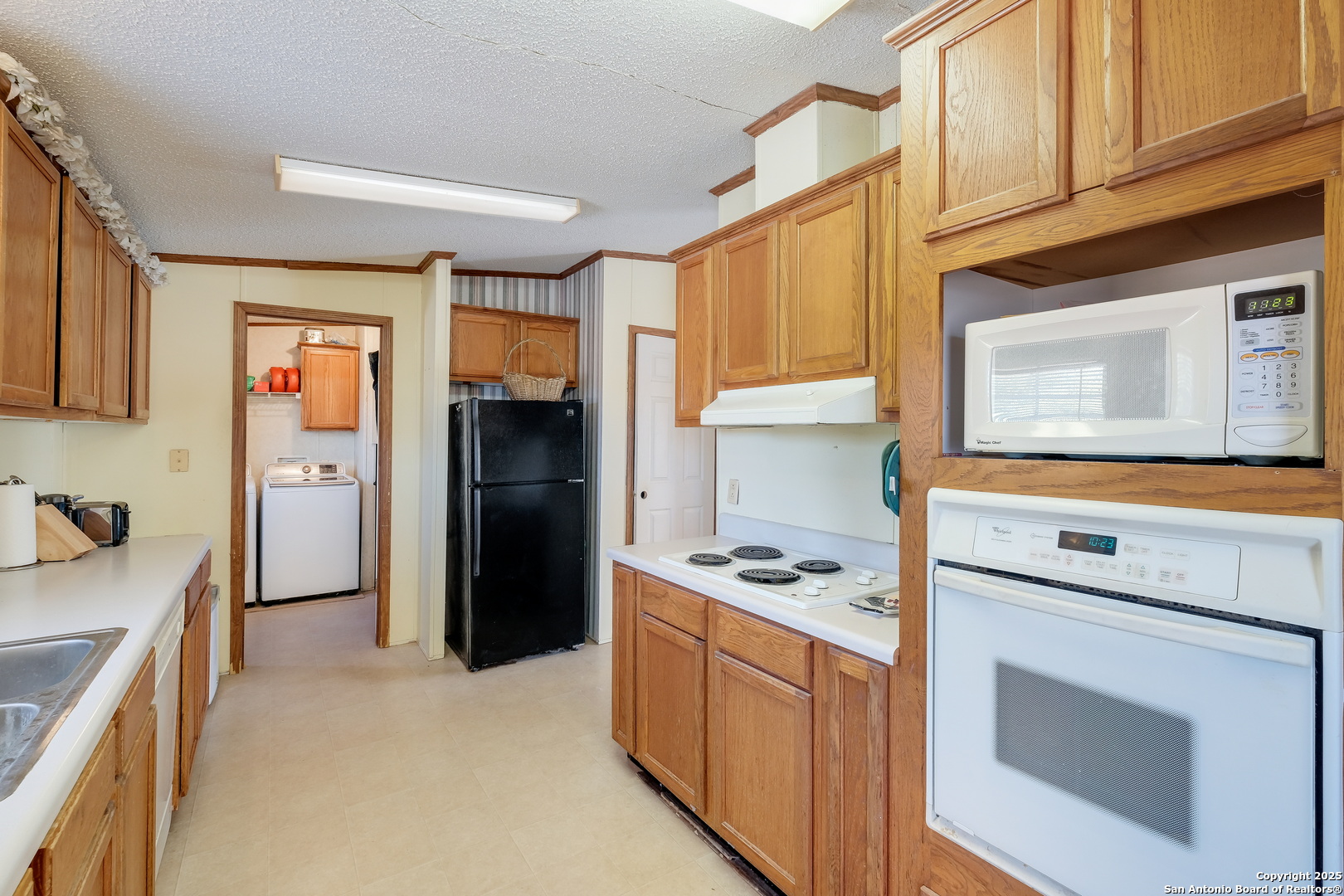 104 Kickapoo Trail Seguin, TX 78155 - Photo 13 of 21 a kitchen with stainless steel appliances a stove microwave and cabinets