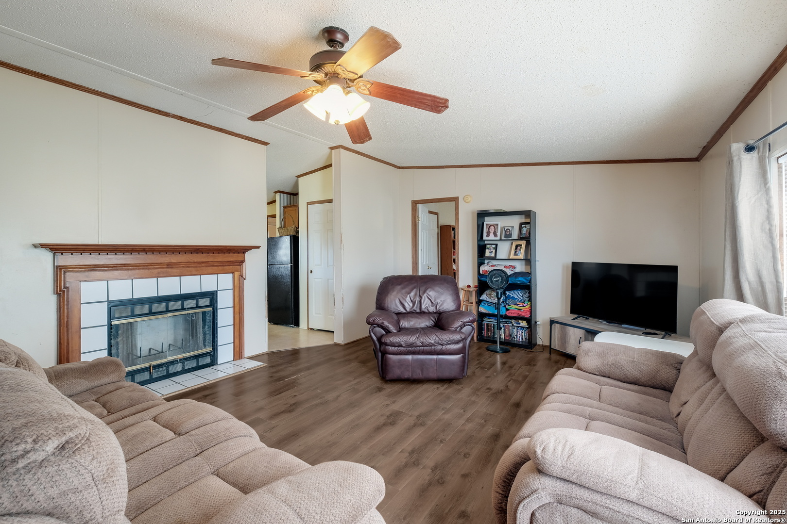 104 Kickapoo Trail Seguin, TX 78155 - Photo 2 of 21 a living room with furniture a fireplace and a flat screen tv
