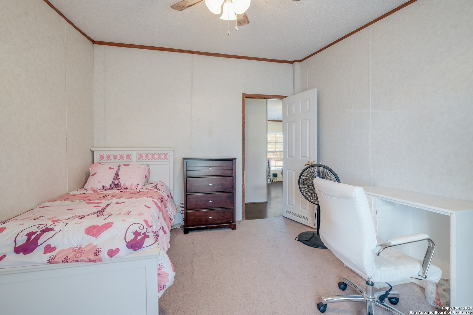 104 Kickapoo Trail Seguin, TX 78155 - Photo 6 of 21 a bedroom with a bed and a chandelier