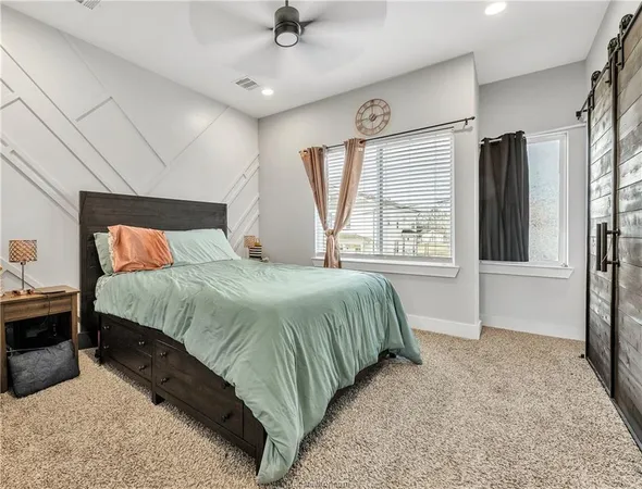 a bedroom with a large bed and a large window