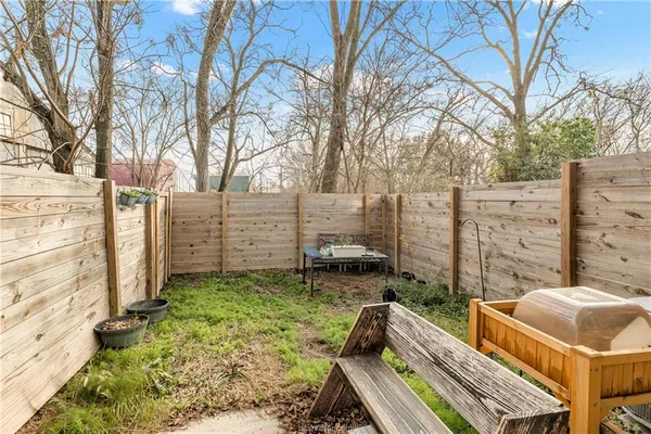 a view of an outdoor sitting area with brick wall