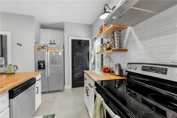 a kitchen with stainless steel appliances granite countertop a stove and a refrigerator