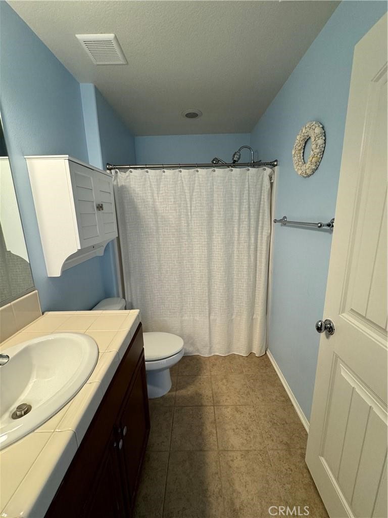 20323 Livorno Way Porter Ranch, CA 91326 - Photo 8 of 14 a bathroom with a sink and a toilet