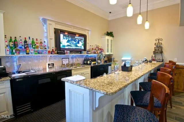 a kitchen with kitchen island a counter top space appliances and cabinets
