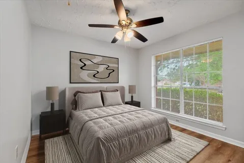 a bedroom with a large bed and a window