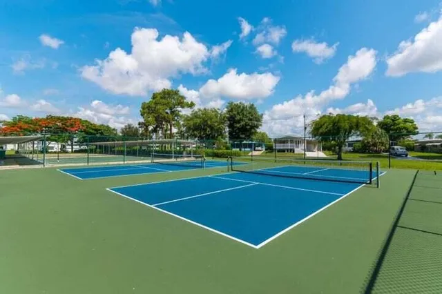 a large kitchen with a table and chairs