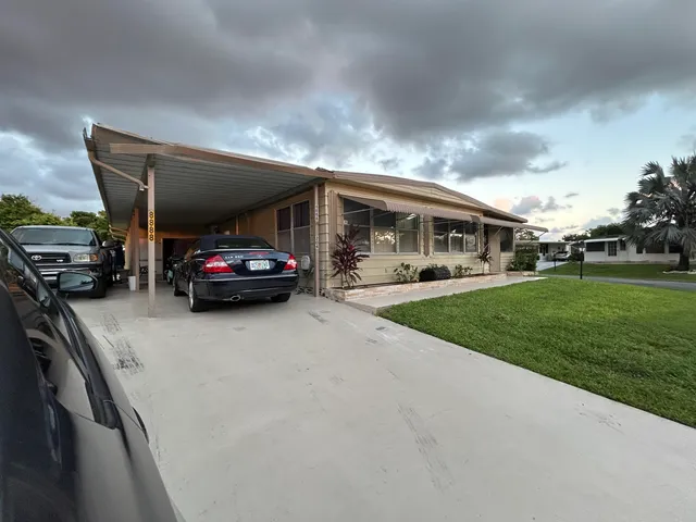 a view of a big yard with table and chairs