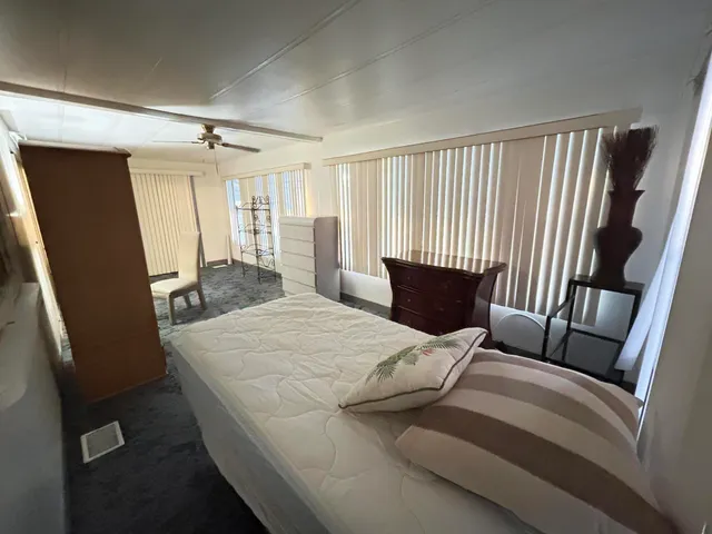 a bedroom with a bed and a mirror