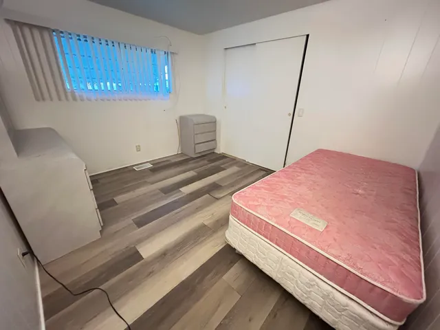 a kitchen with stainless steel appliances granite countertop a refrigerator sink and wooden cabinets