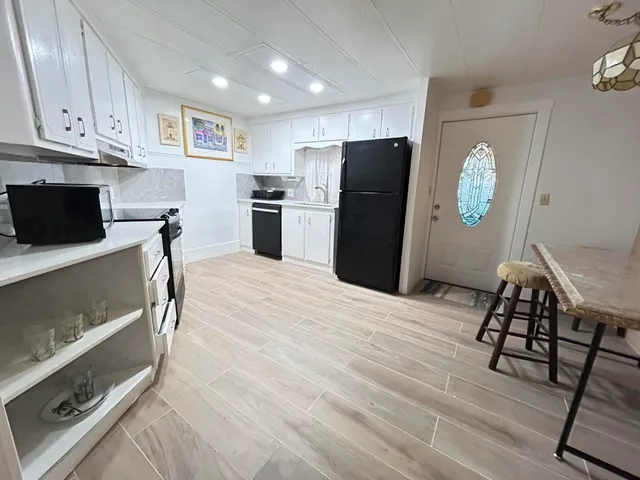 a kitchen with stainless steel appliances a refrigerator and microwave