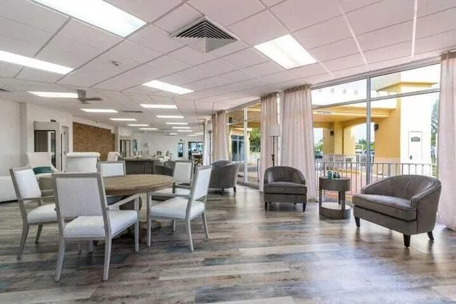 a dining room with furniture window and wooden floor