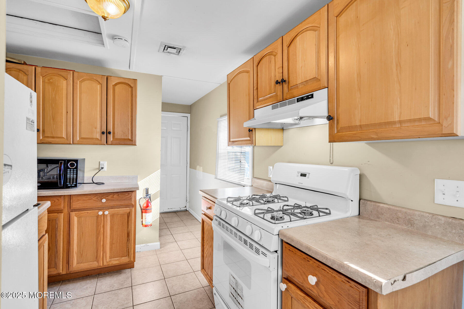 549 Brielle Road, Unit 1/2 Manasquan, NJ 08736 - Photo 5 of 10 a kitchen with a stove a sink and a refrigerator