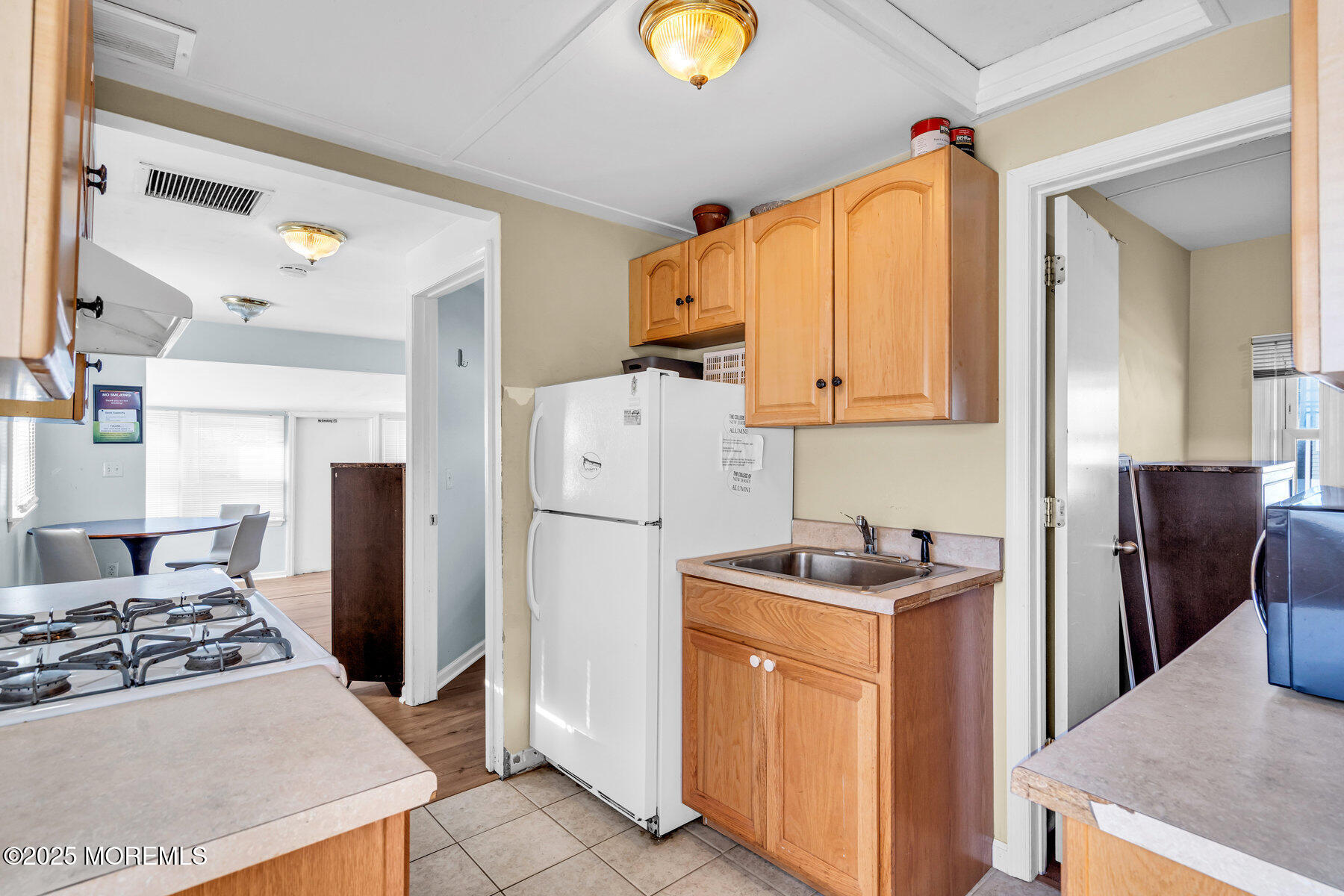 549 Brielle Road, Unit 1/2 Manasquan, NJ 08736 - Photo 6 of 10 a kitchen with refrigerator and stove