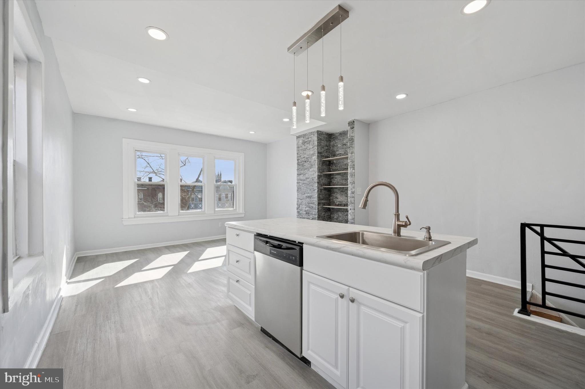 5031 Walnut Street, Unit 3 Philadelphia, PA 19139 - Photo 2 of 7 a kitchen with a sink cabinets and wooden floor
