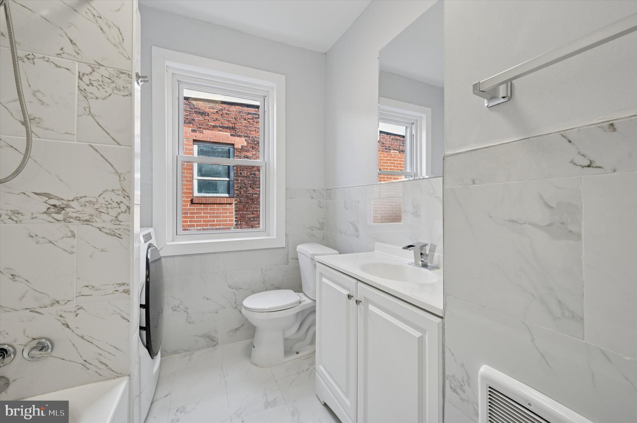 5031 Walnut Street, Unit 3 Philadelphia, PA 19139 - Photo 5 of 7 a bathroom with a sink toilet and shower