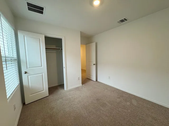 a view of an empty room and a window