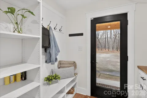 a view of entryway and hall with wooden floor