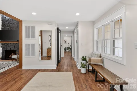a living room with furniture wooden floor and a flat screen tv