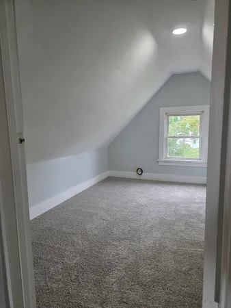 a view of an empty room and a window