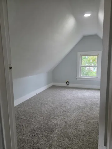 a view of an empty room and a window