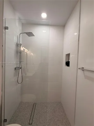 a view of a dining room with furniture and a potted plant