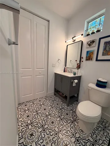 a bedroom with a bed and a flat tv screen on the dresser