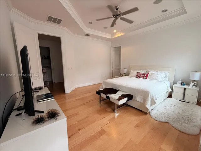 a view of swimming pool with lawn chairs and plants