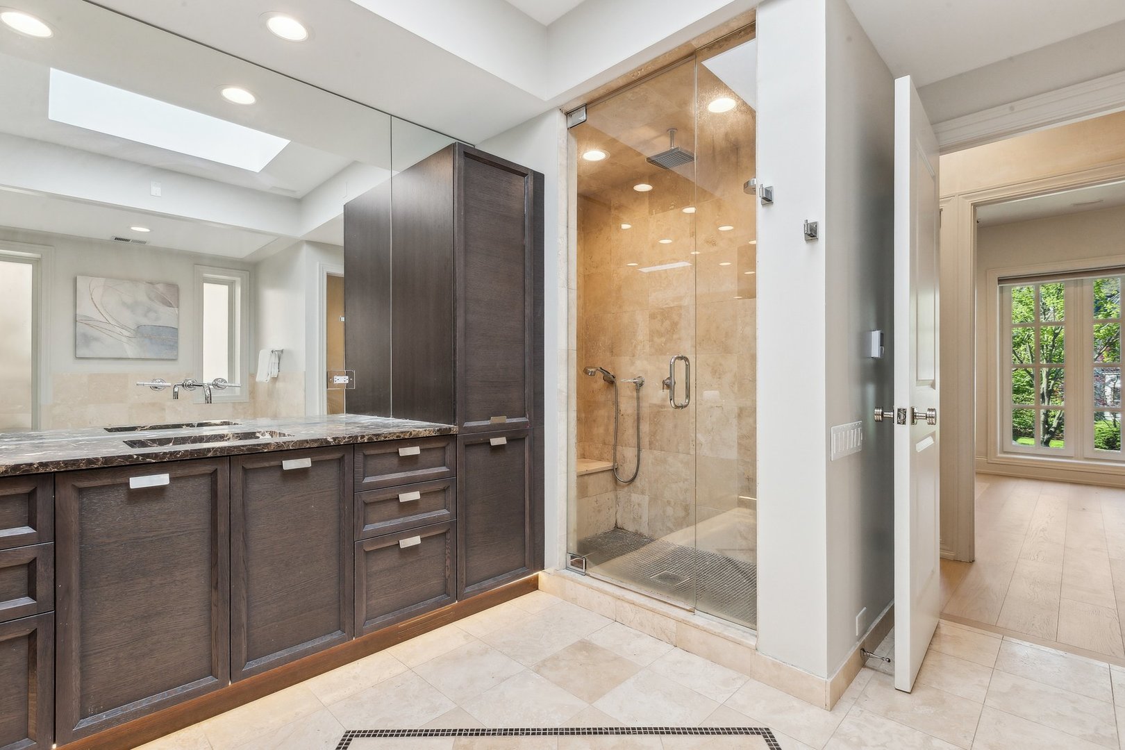 579 West Hawthorne Place Chicago, IL 60657 - Photo 38 of 65 a bathroom with a granite countertop sink mirror and shower