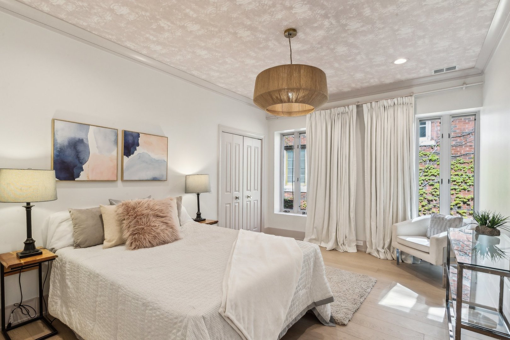 579 West Hawthorne Place Chicago, IL 60657 - Photo 40 of 65 a bedroom with a bed and a chandelier