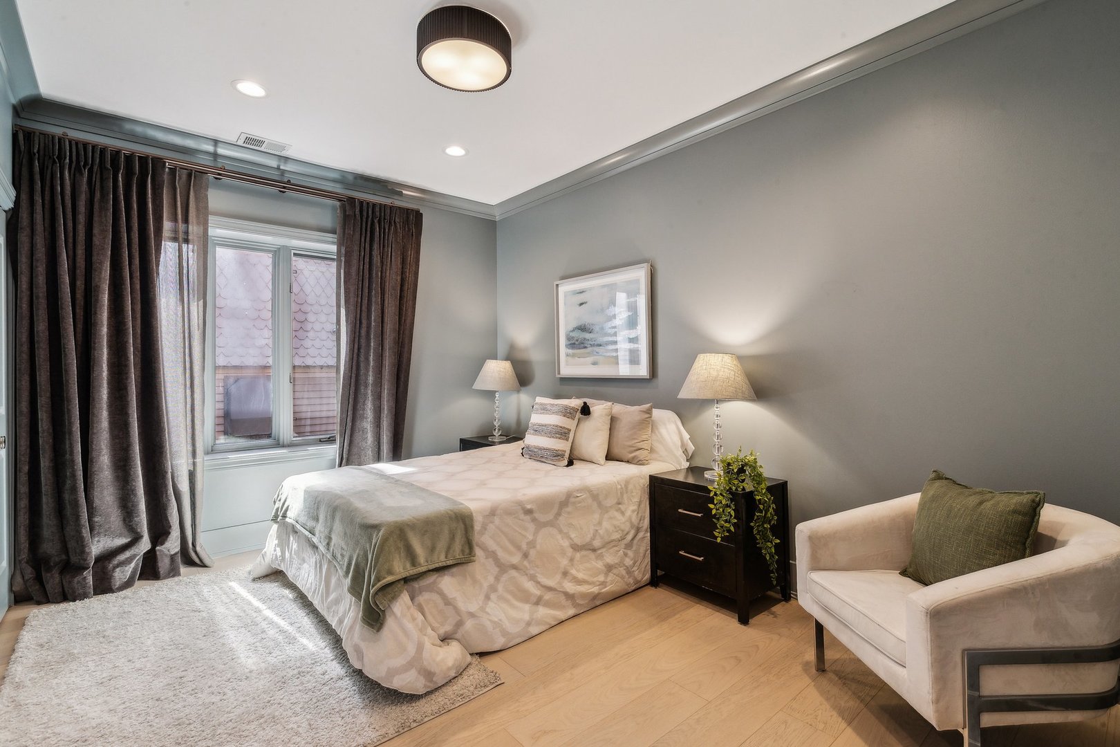 579 West Hawthorne Place Chicago, IL 60657 - Photo 45 of 65 a bedroom with a bed and a large window