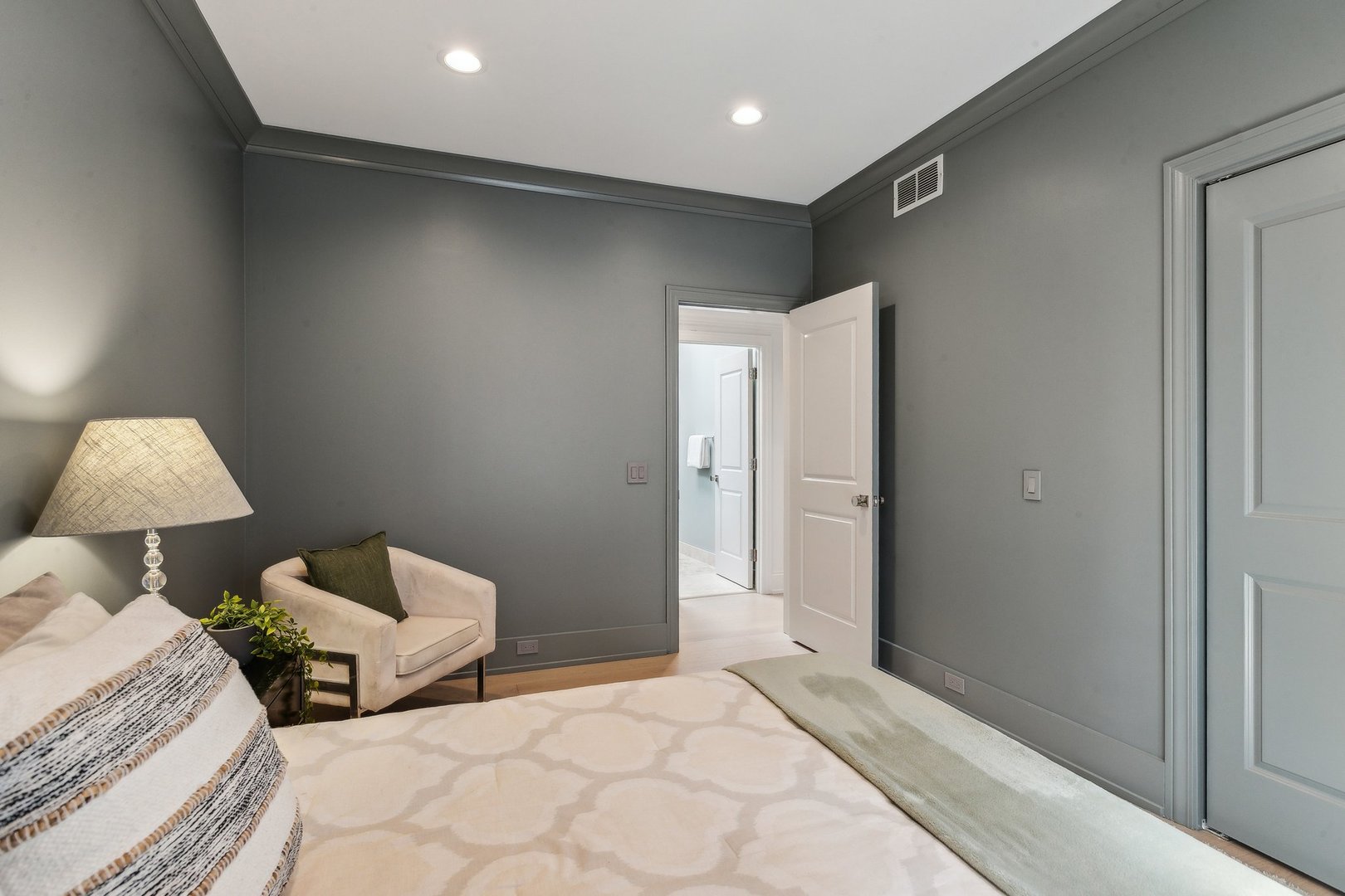 579 West Hawthorne Place Chicago, IL 60657 - Photo 46 of 65 a spacious bedroom with a bed and a lamp