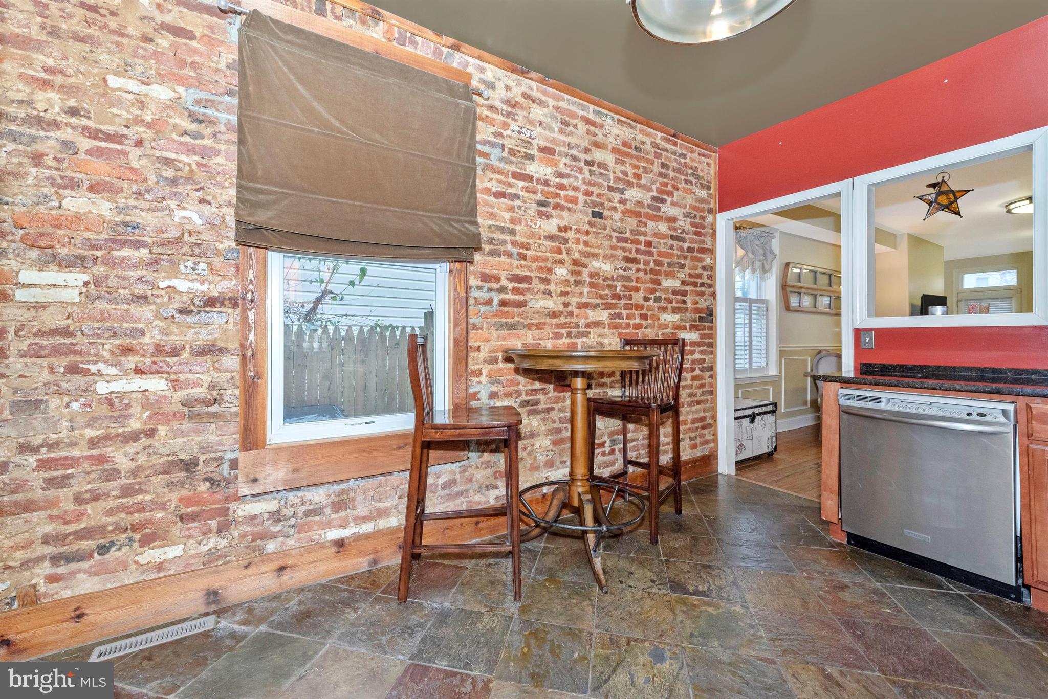 207 Center Street Frederick, MD 21701 - Photo 16 of 36 Breakfast area with exposed brick wall.