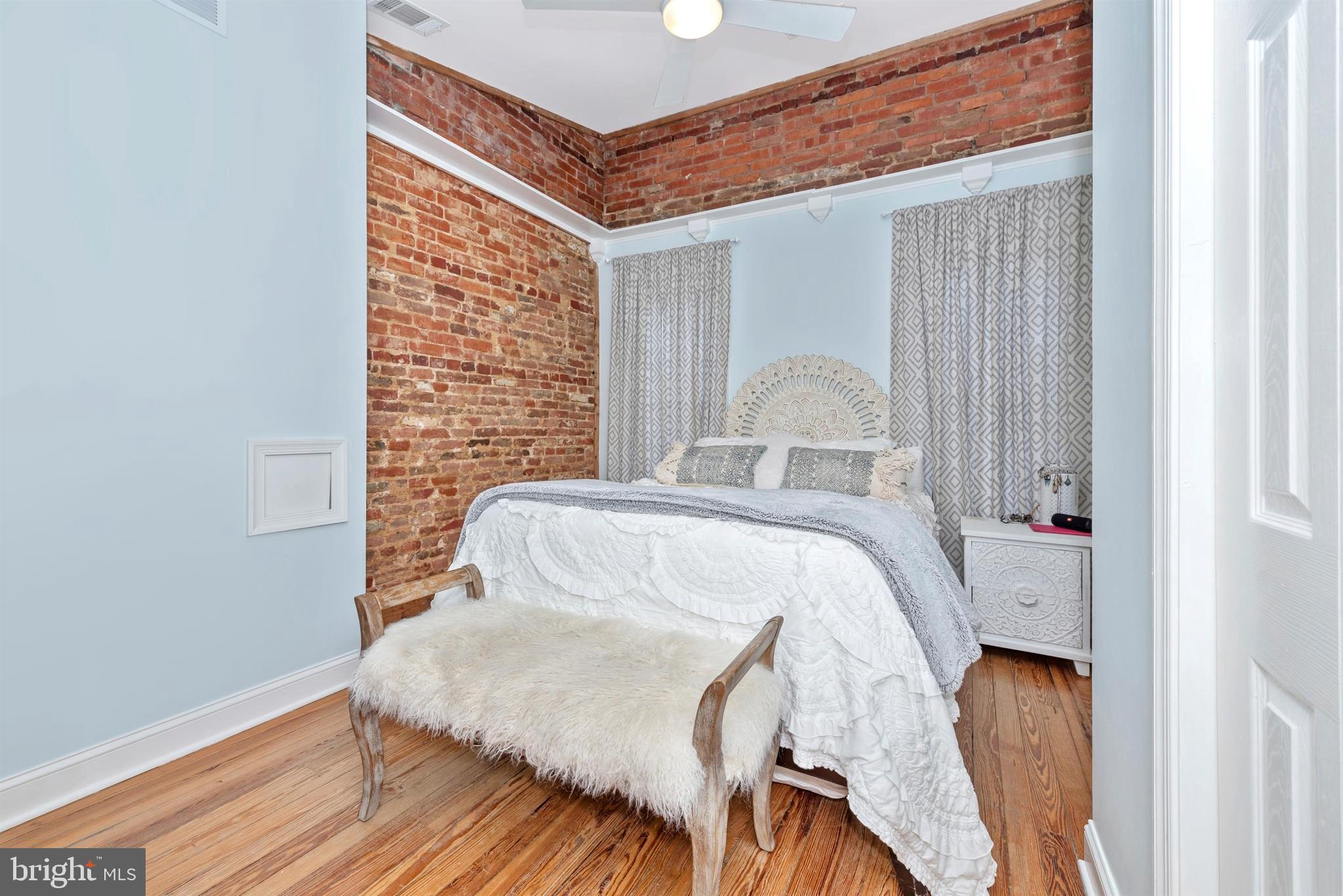207 Center Street Frederick, MD 21701 - Photo 18 of 36 First of two master suites - exposed brick wall.