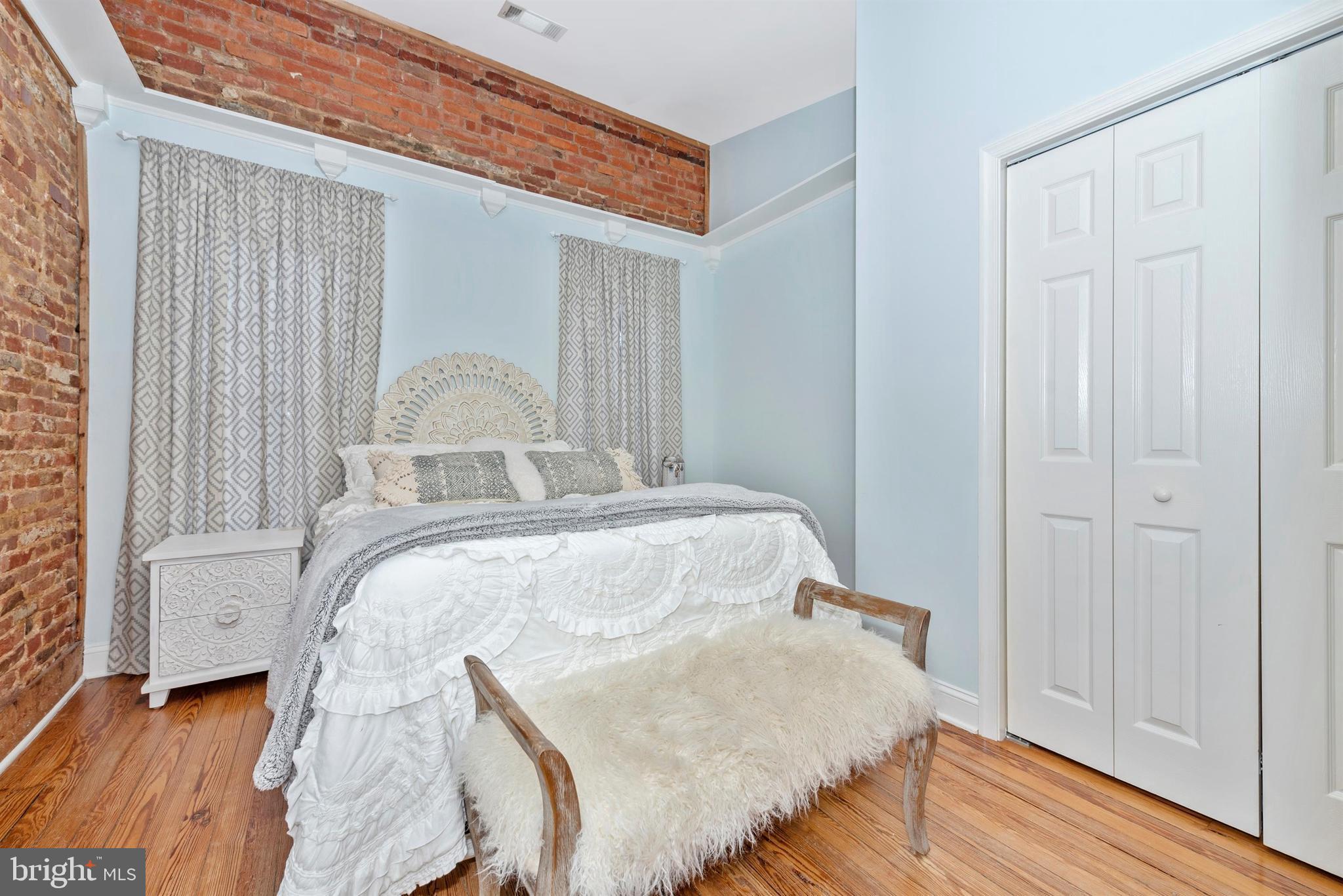 207 Center Street Frederick, MD 21701 - Photo 19 of 36 First of two master suites - exposed brick wall.