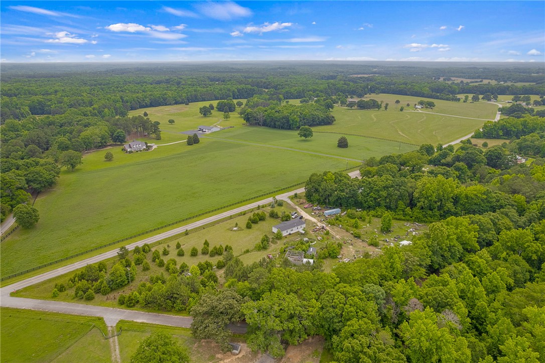 1549 Bethany Church Road Belton, SC 29627 - Photo 2 of 36 Acres of pristine land with scattered residences, framed by lush forests and open fields.