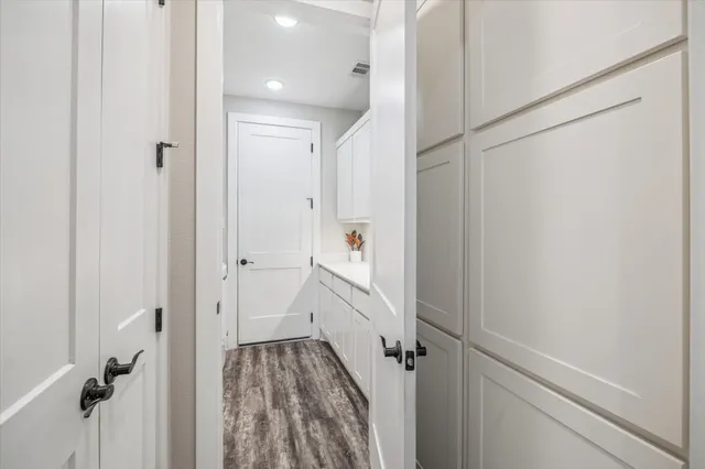 a view of washer and dryer with kitchen in the background