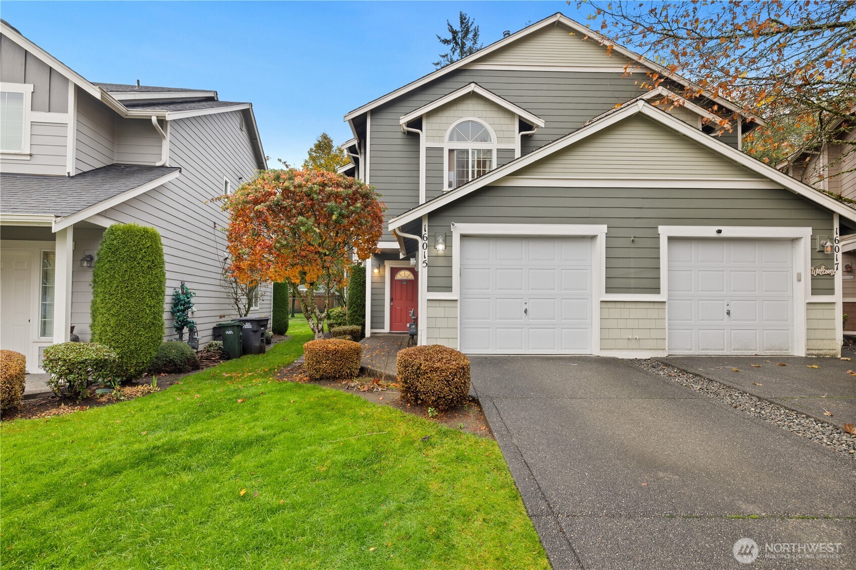 a front view of a house with a yard and garage
