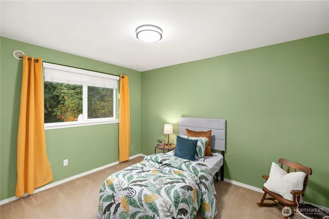 a bedroom with a bed and windows