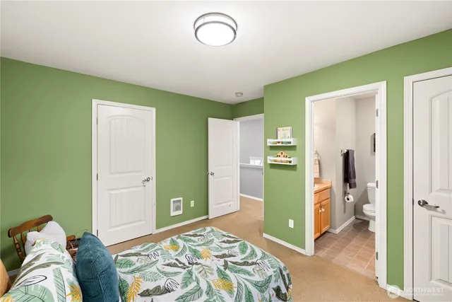 a bedroom with a bed and a mirror