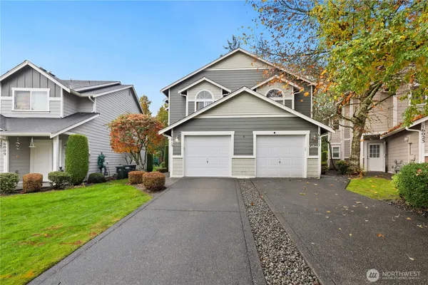 a front view of a house with a yard and garage