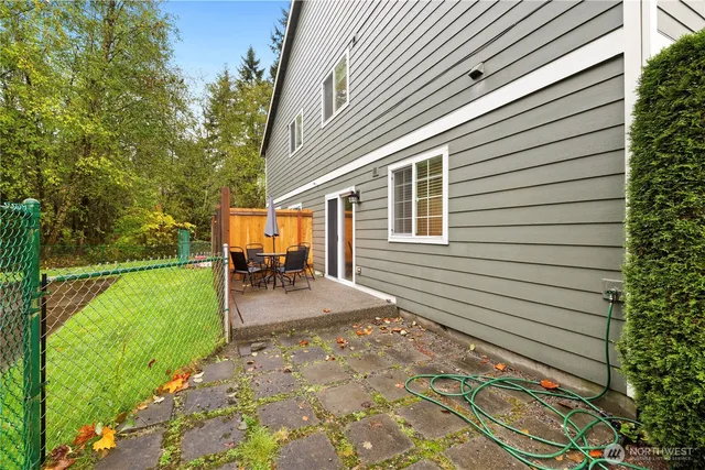 a view of a backyard with plants and a patio