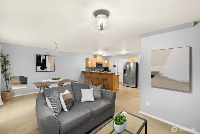 a living room with furniture and a chandelier